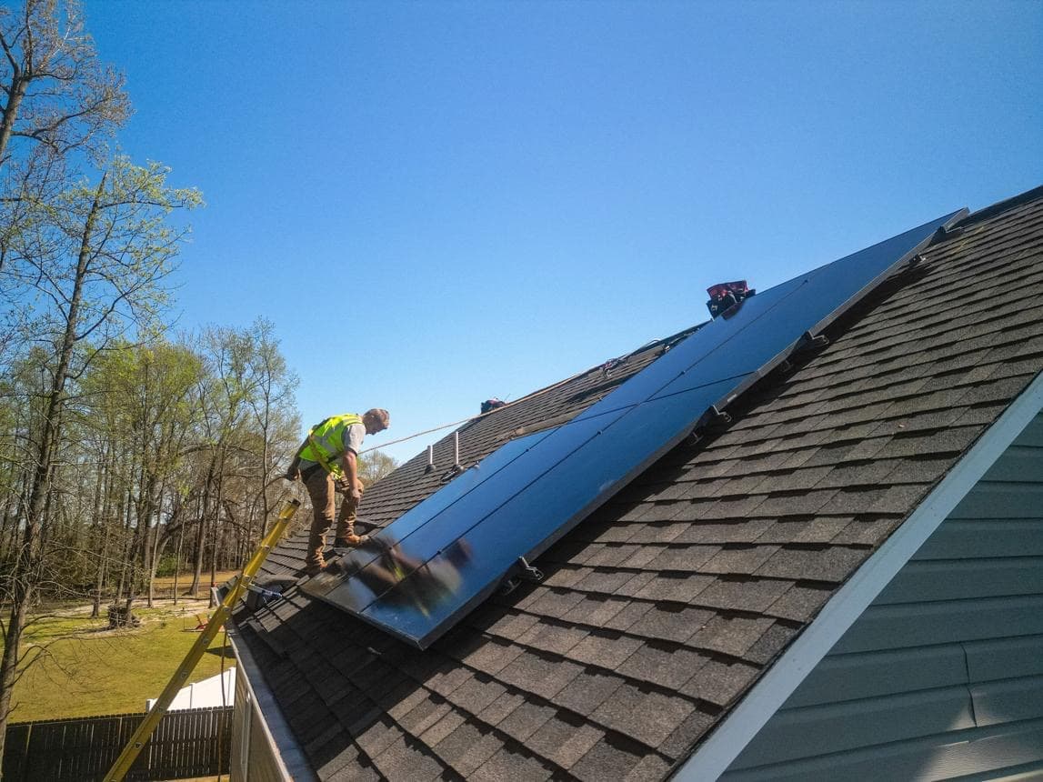 Solar technician servicing a residential solar system